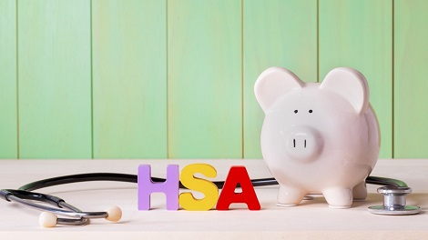 Pig next to a stethoscope to show IRS Announces Change to 2018 HSA Family Contribution Limits