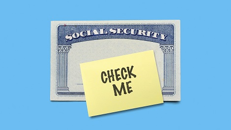 Social security card with a note that says 'Check me' on it to signify social security administration revises 2018 taxable Wage Base cost of living Adjustment 